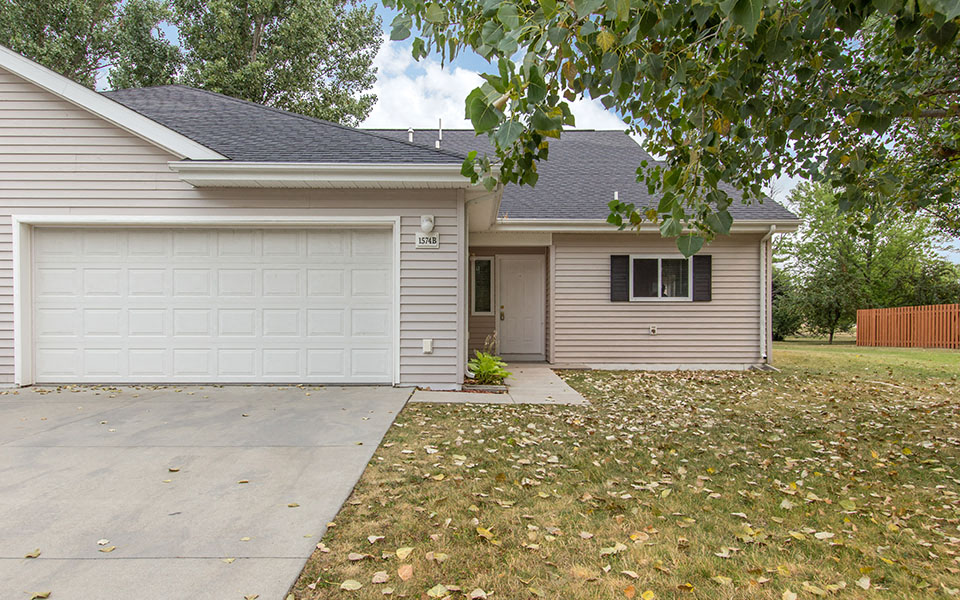 a white house with a driveway and a white garage door