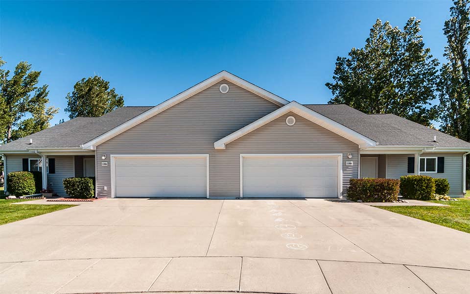 a house with a driveway and a garage door