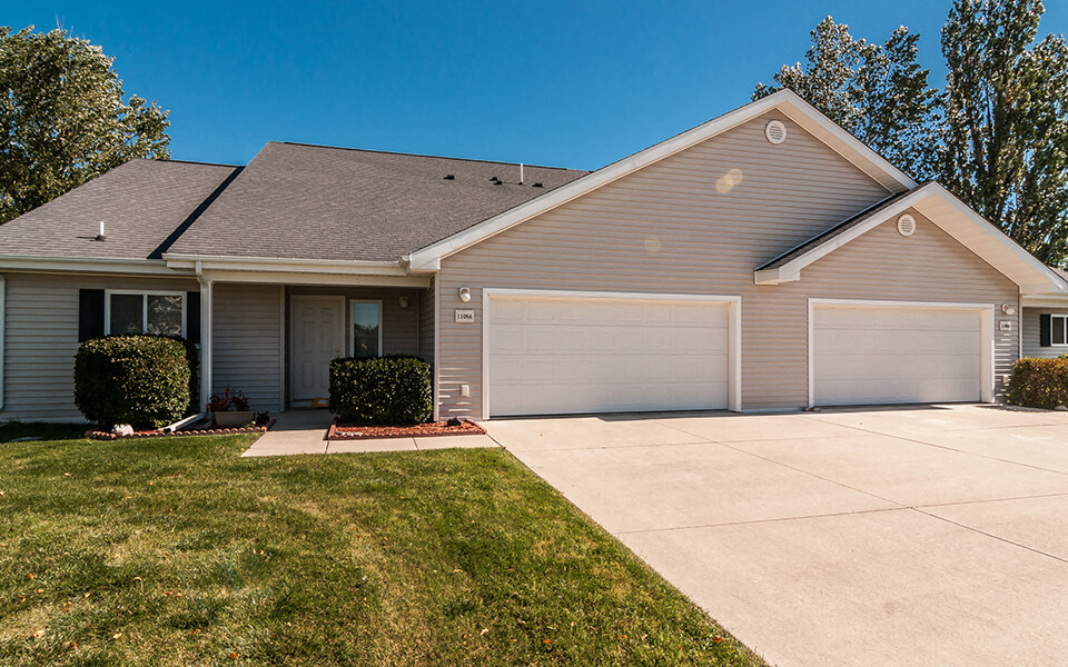 a house with a driveway and a garage door