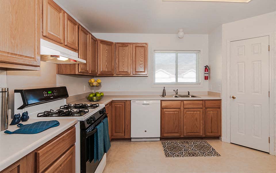 a kitchen with a stove top oven and a sink