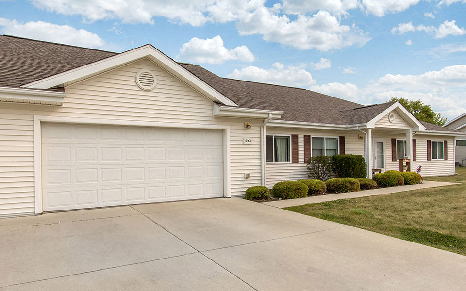 a white house with a white garage door