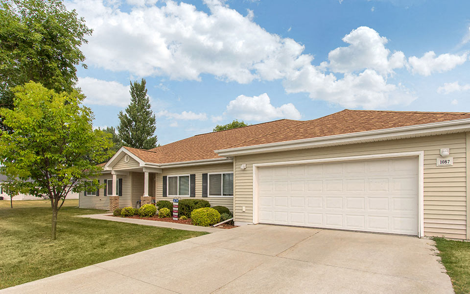 a beige house with a white garage door