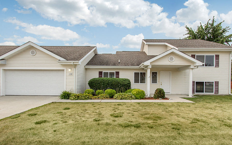 a white house with a lawn in front of it