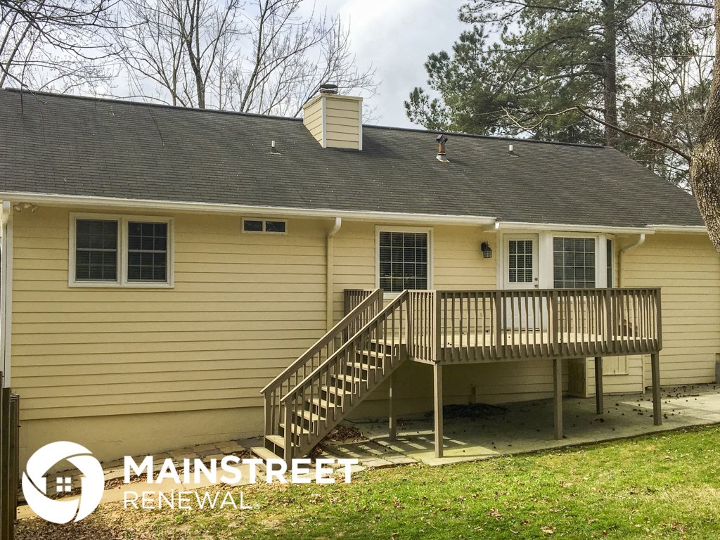 a home with a deck and a ramp to the side of it