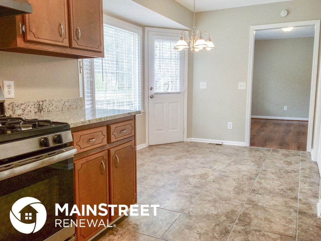 an empty kitchen with a stove and a door