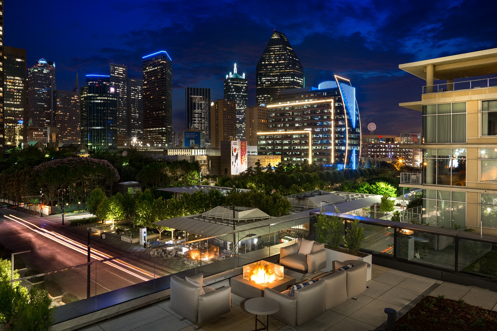 a view of the city from a rooftop terrace at night