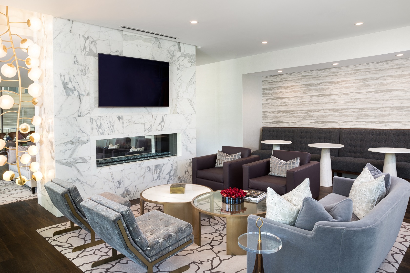 a living room with couches and chairs and a fireplace