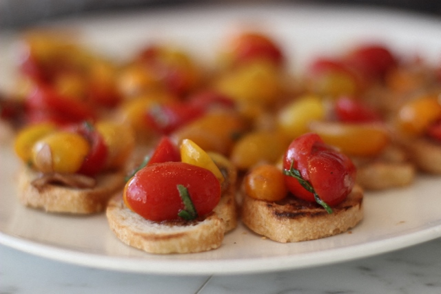 a plate topped with small bites of bread with fruit on it