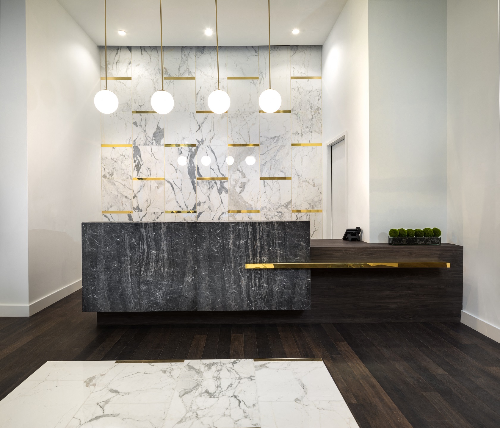 a marble reception desk in a hotel lobby