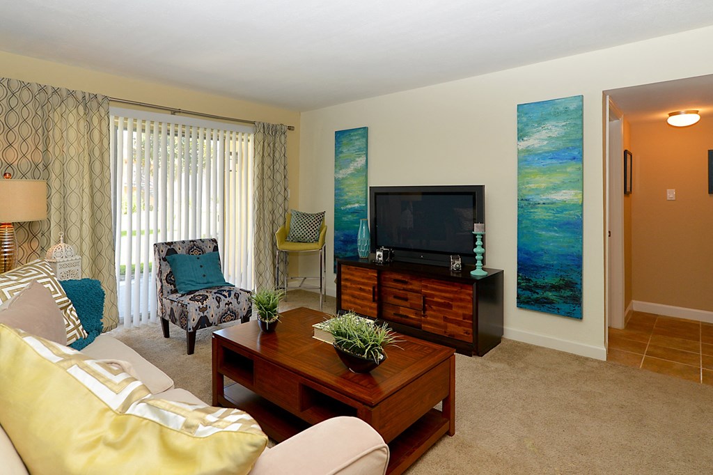 Living room with a tv and a couch at Broadwater Apartments in St Petersburg, FL 33711
