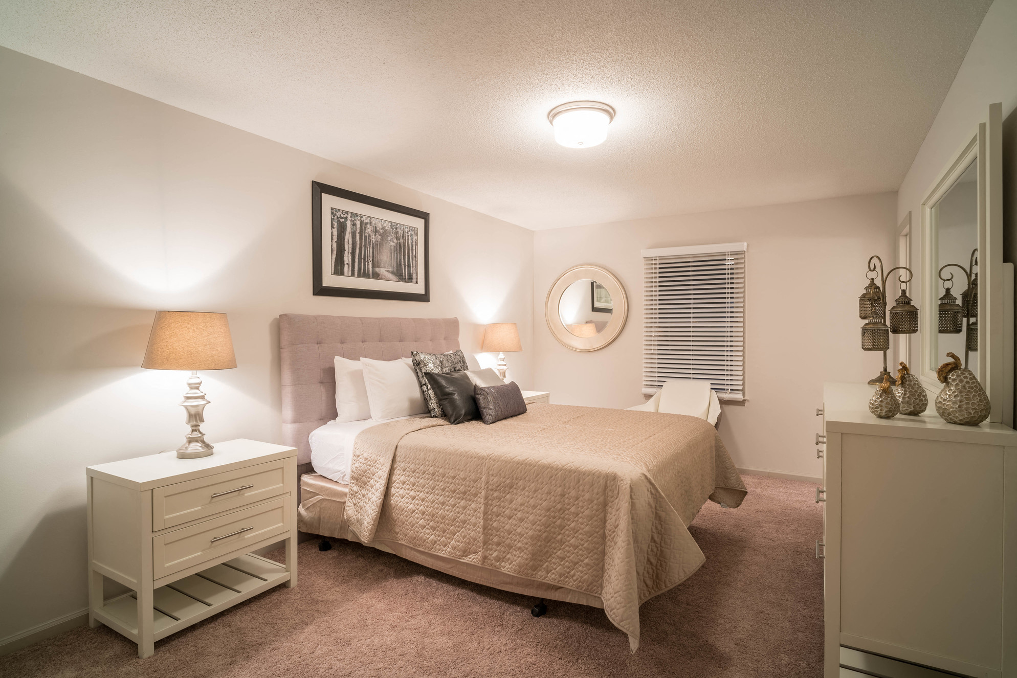 a bedroom with a bed and a dresser and a window