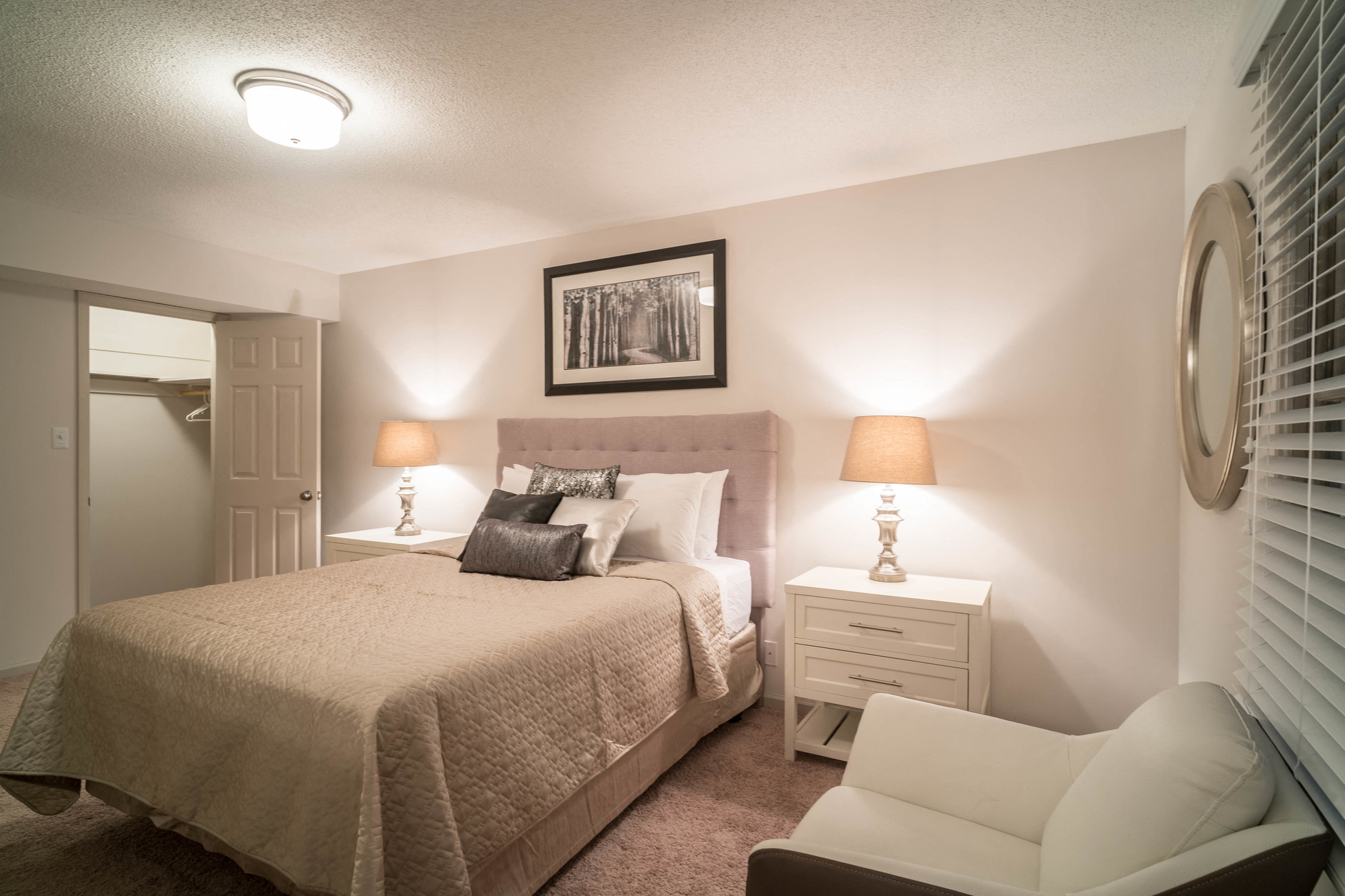 a bedroom with a bed and a dresser and a window