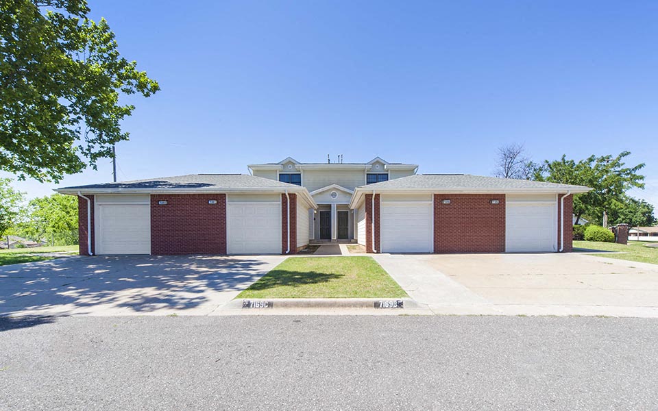 a house with two garage doors and a driveway