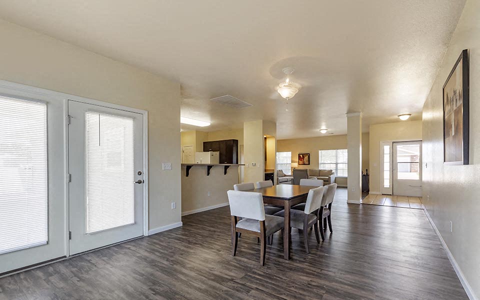 a dining room and living room with a table and chairs