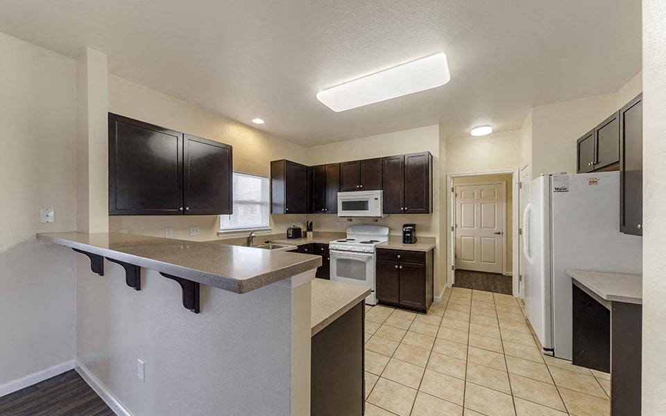 a kitchen with a counter and a refrigerator