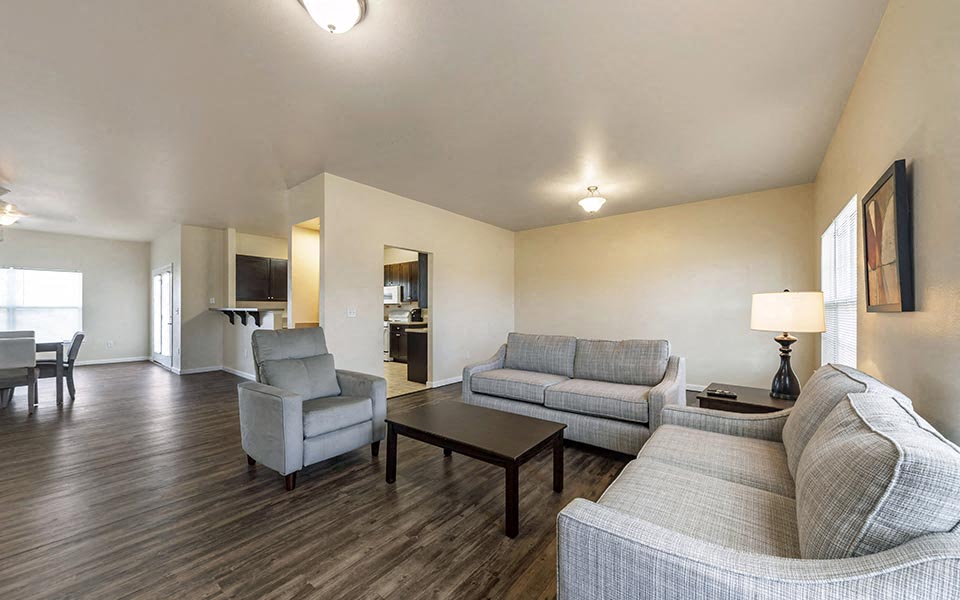 a living room with couches and chairs and a table