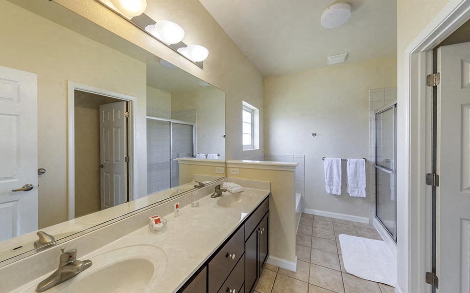 a large bathroom with a sink and a mirror