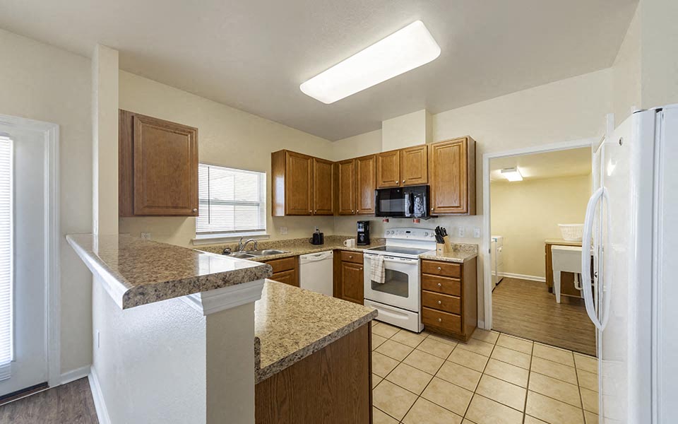 a kitchen with a stove and a refrigerator