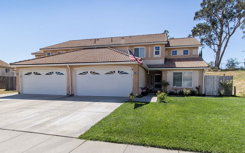 a house with a flag on the driveway