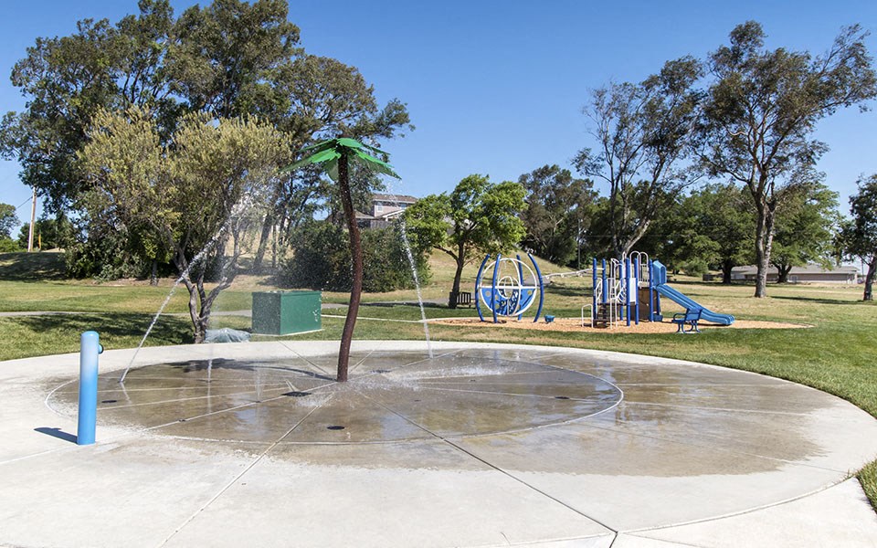 a park with a playground and a water fountain