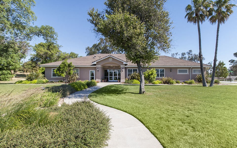 a house with a sidewalk and lawn in front of it