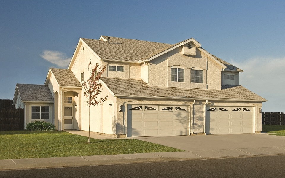 a white house with a garage and a driveway