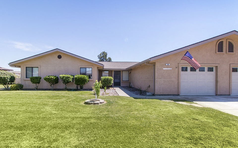 a house with a lawn and an flag