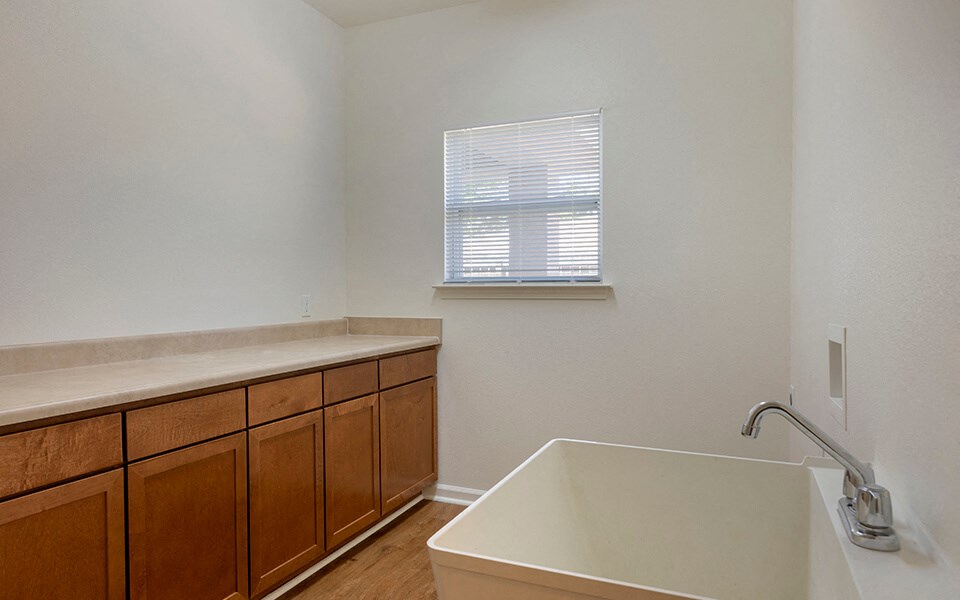 a kitchen with a sink and a tub and a window