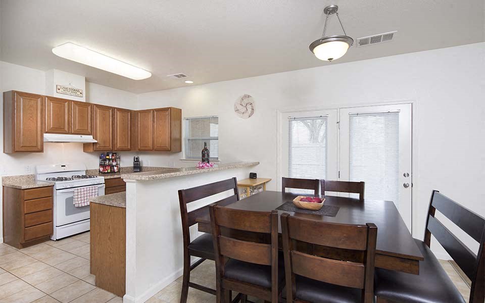 a kitchen and dining room with a table and chairs
