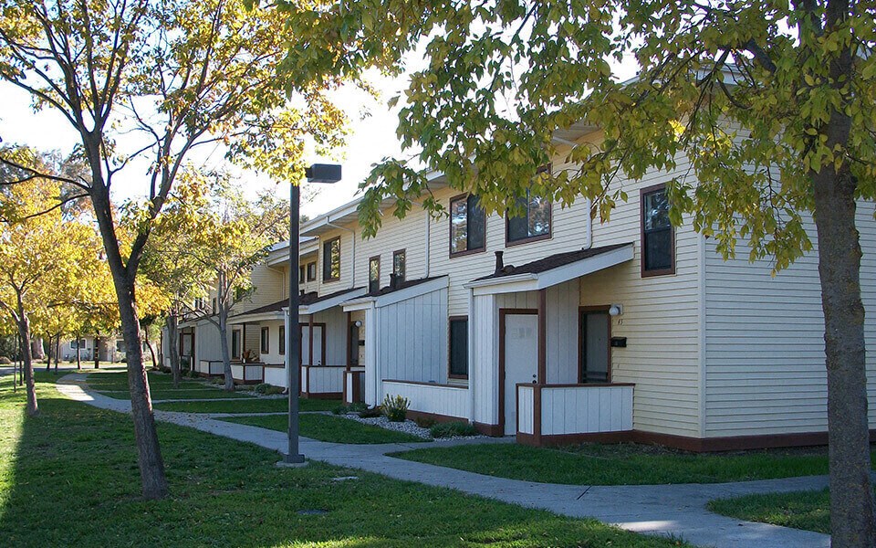 a row of houses on a street with trees