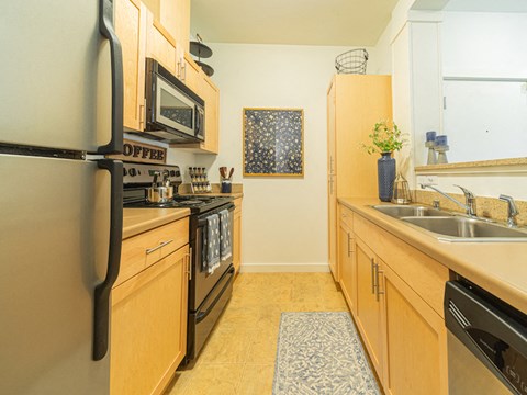 a kitchen with stainless steel appliances and wooden cabinets