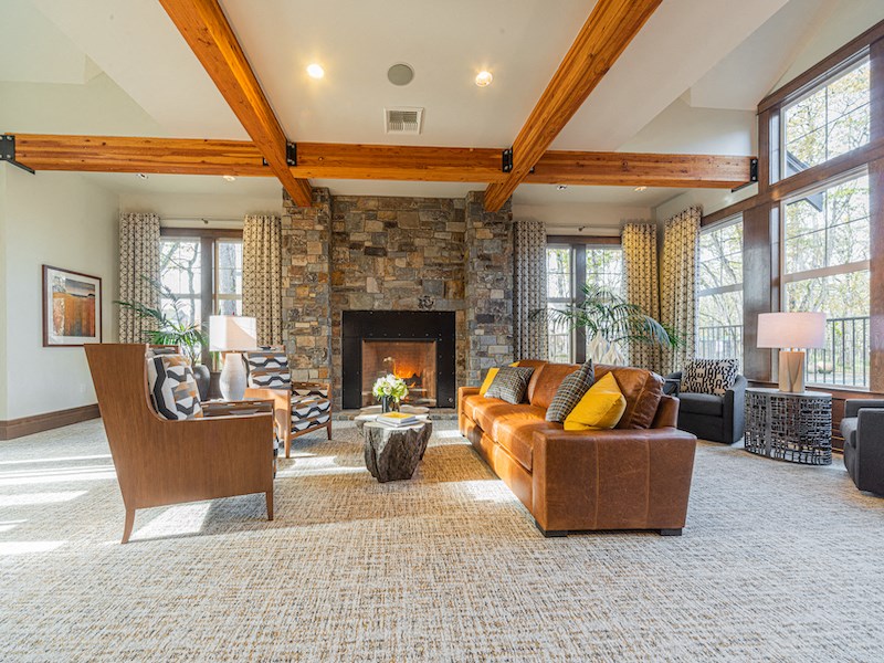 a large living room with a stone fireplace and furniture