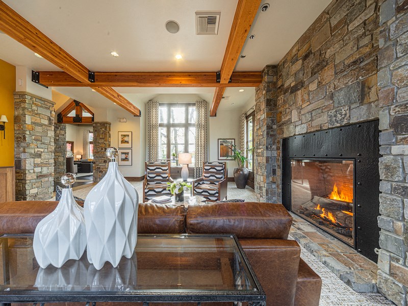 the living room has a large fireplace and leather couches