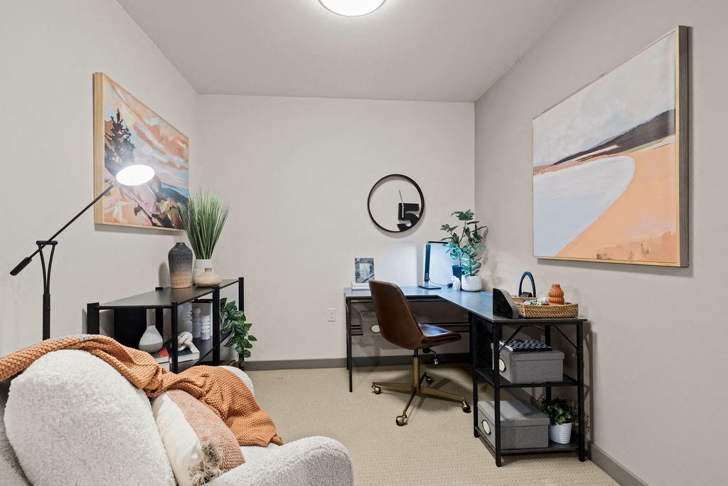 a living room with a couch and a desk