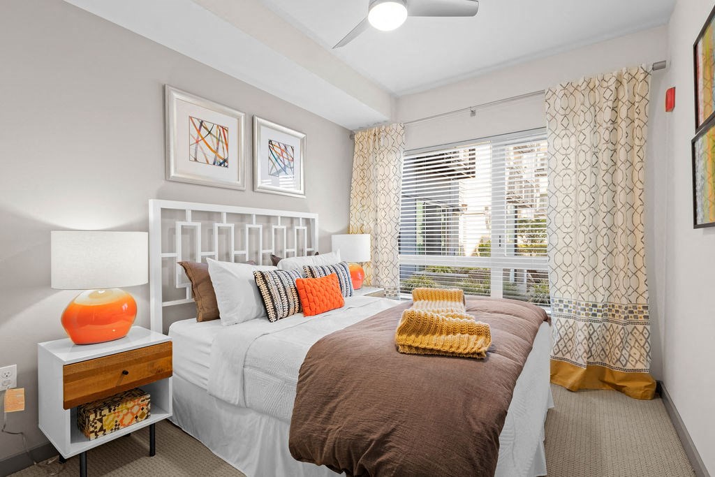 a bedroom with a large bed and a window