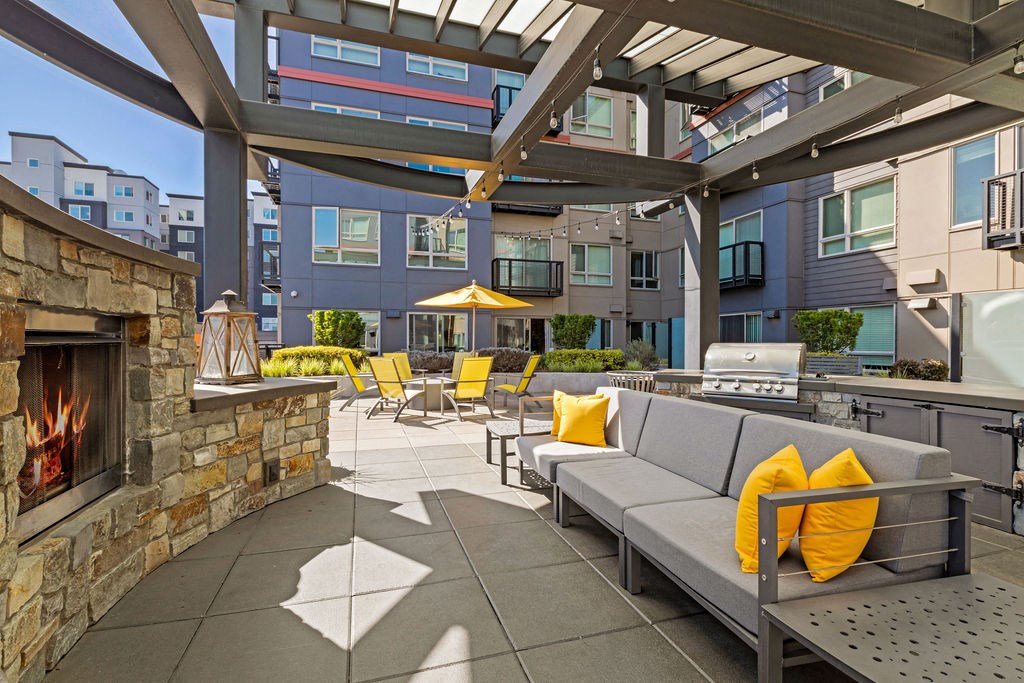 a patio with furniture and a fireplace
