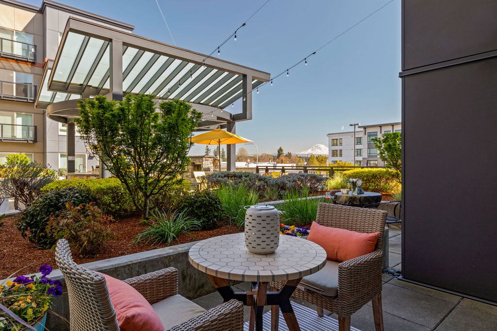 a patio with a table and chairs on a balcony