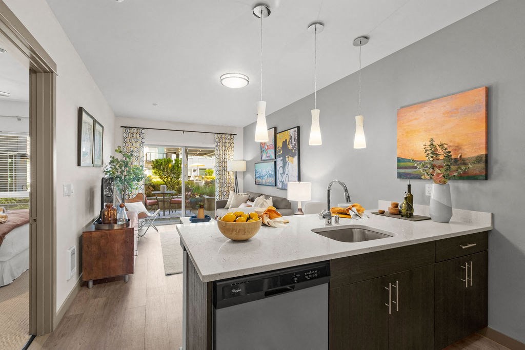 a kitchen with a sink and a counter top in a living room
