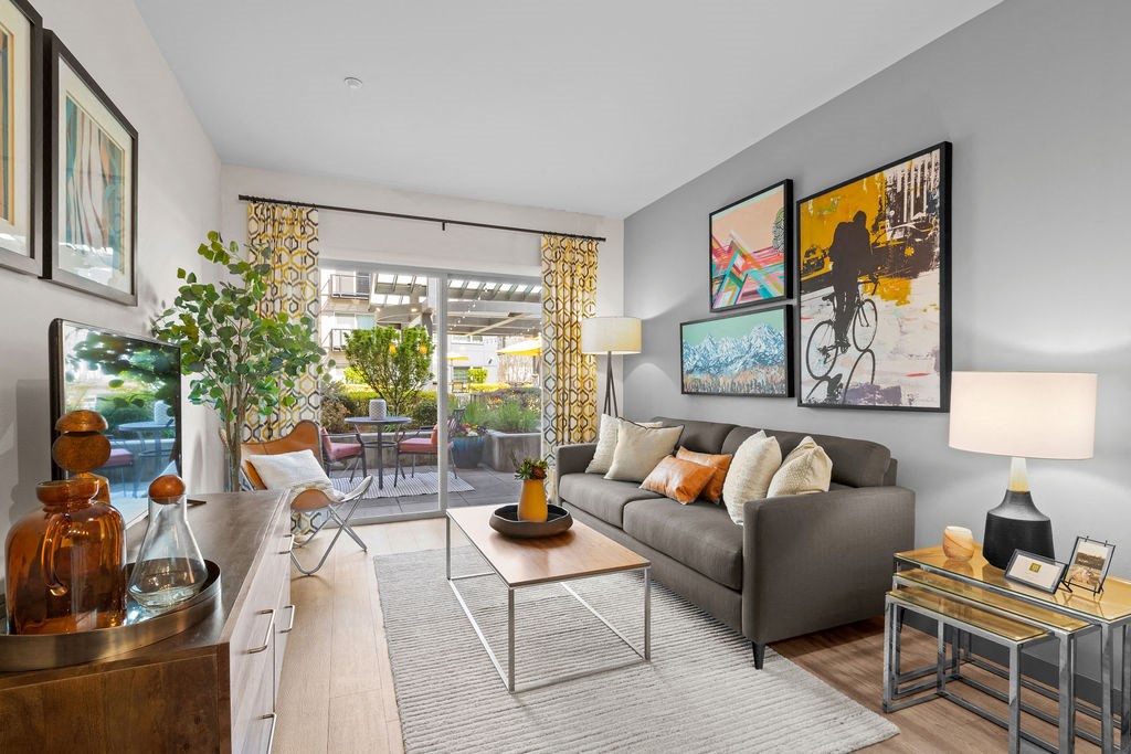a living room with gray walls and a sliding glass door to a patio