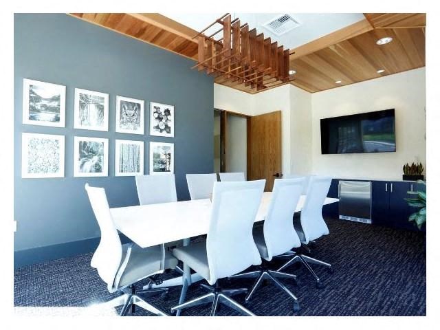 a conference room with a white table and chairs
