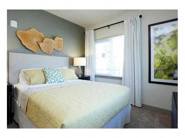 a bedroom with a large bed and a window