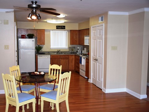 a kitchen and dining room with a table and chairs