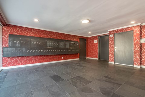 Lobby area with elevator and mail boxes