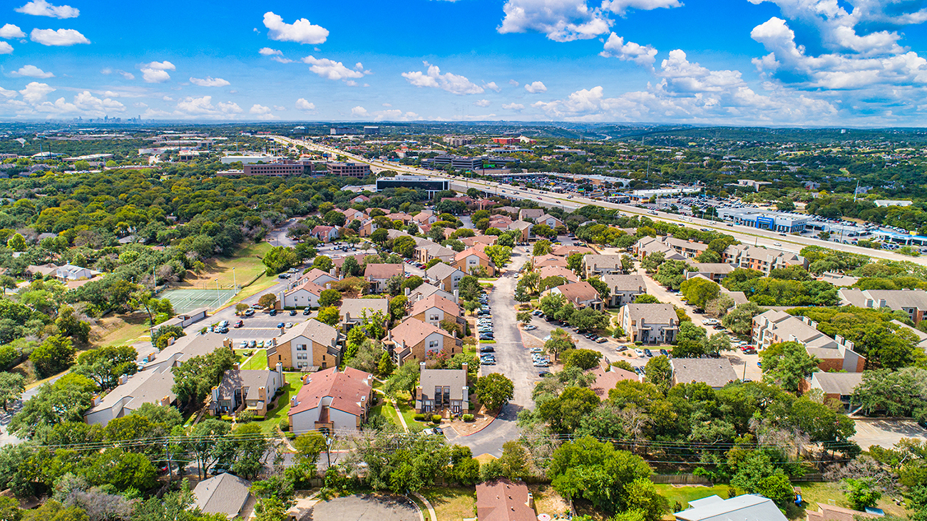 an aerial view of a suburban neighborhood with houses and trees