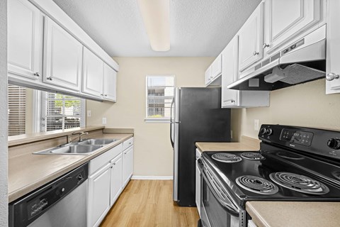 A kitchen with a black stove top oven.
