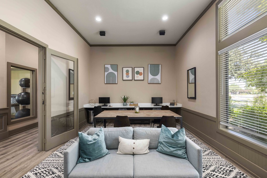 A living room with a grey couch and a wooden table.