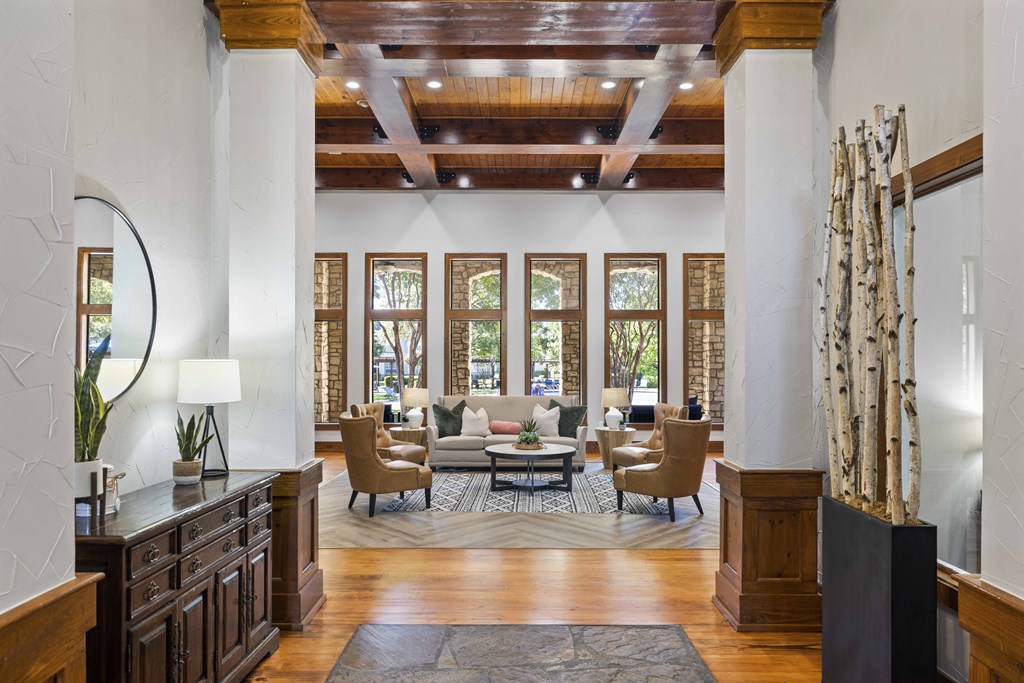 A large room with a wooden floor and a long couch.