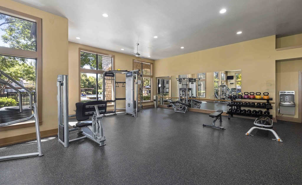 A spacious gym with a variety of equipment including treadmills, weights, and exercise machines.