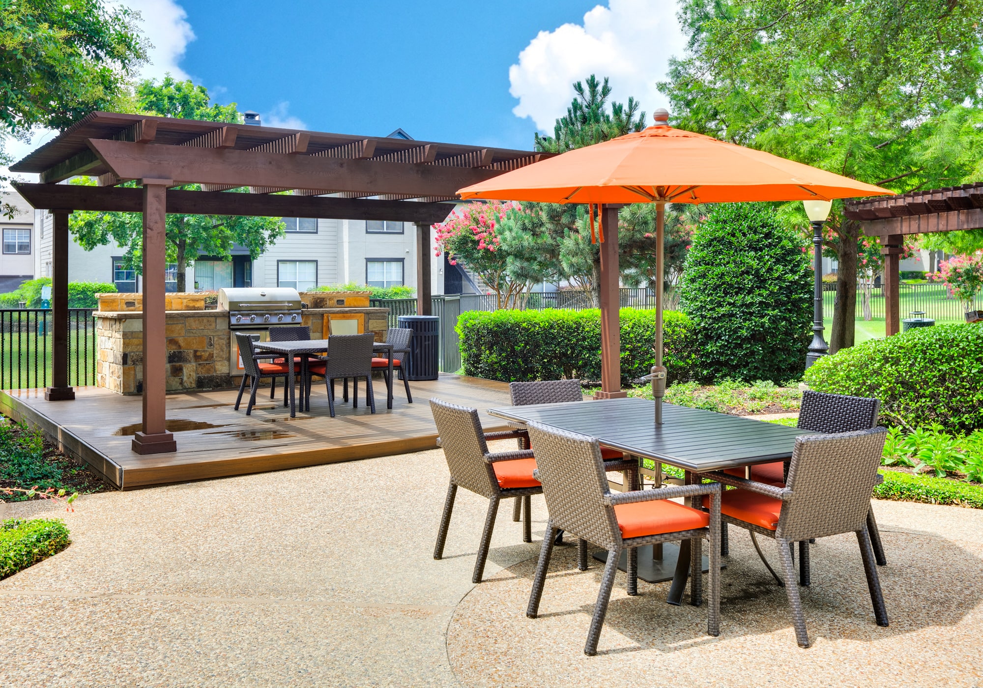 a patio with a table and chairs with an umbrella