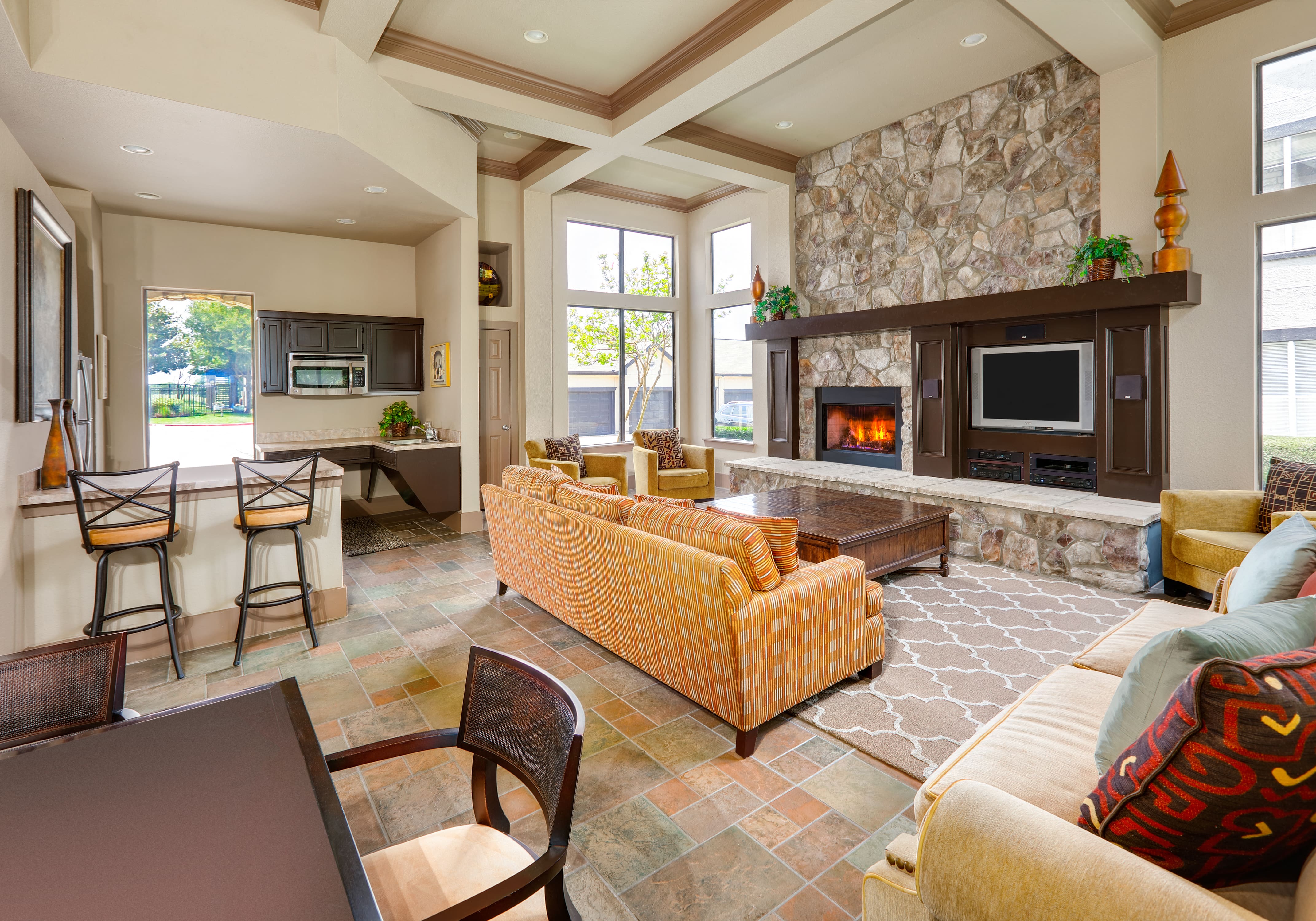 a living room with a fireplace and a table and chairs